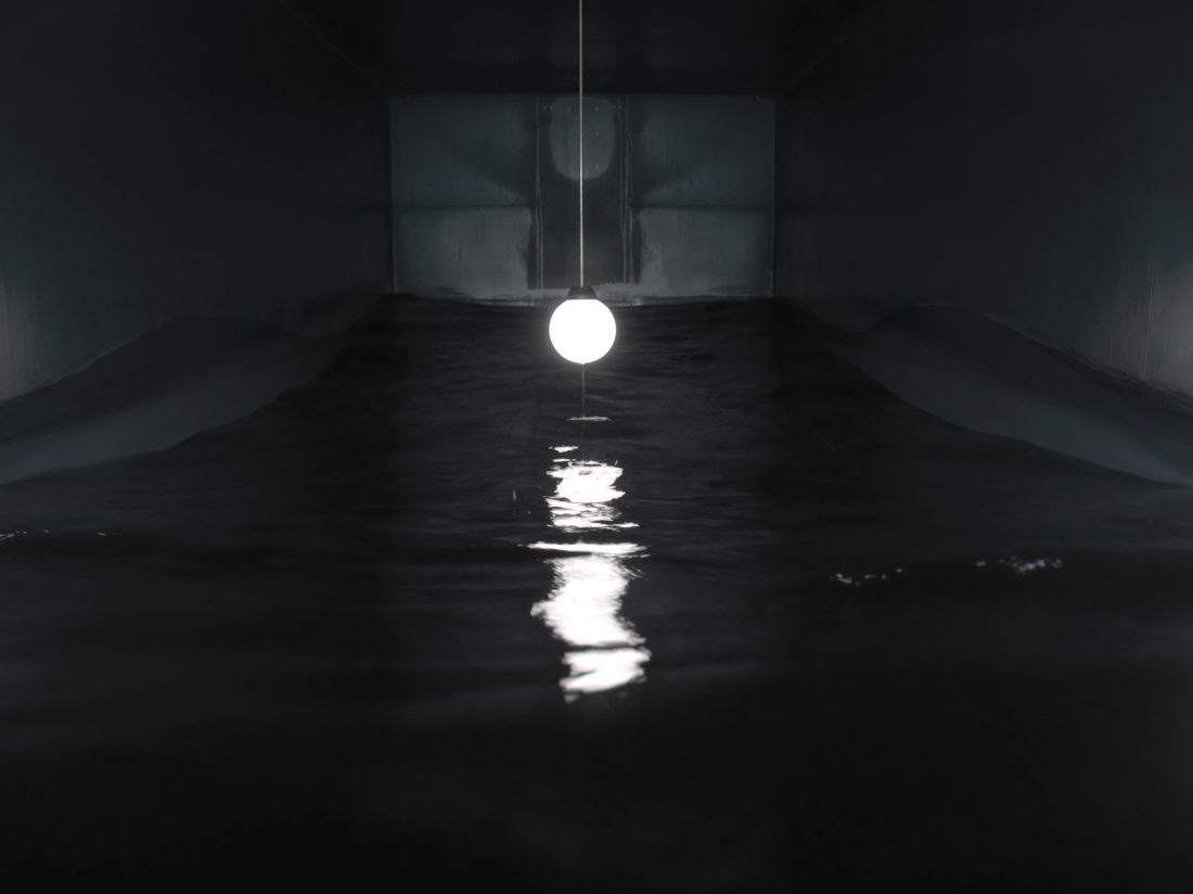 <p>Massimo Bartolini,<em> Sala para uma onda (Room for a wave)</em>, 2005-2007, shipping container, water, lamp, pump. Into a shipping container a wave goes on, covering and uncovering a ceiling globe lamp. Photo: A. Maranzano. Courtesy of the artist and Frith Street Gallery.</p>