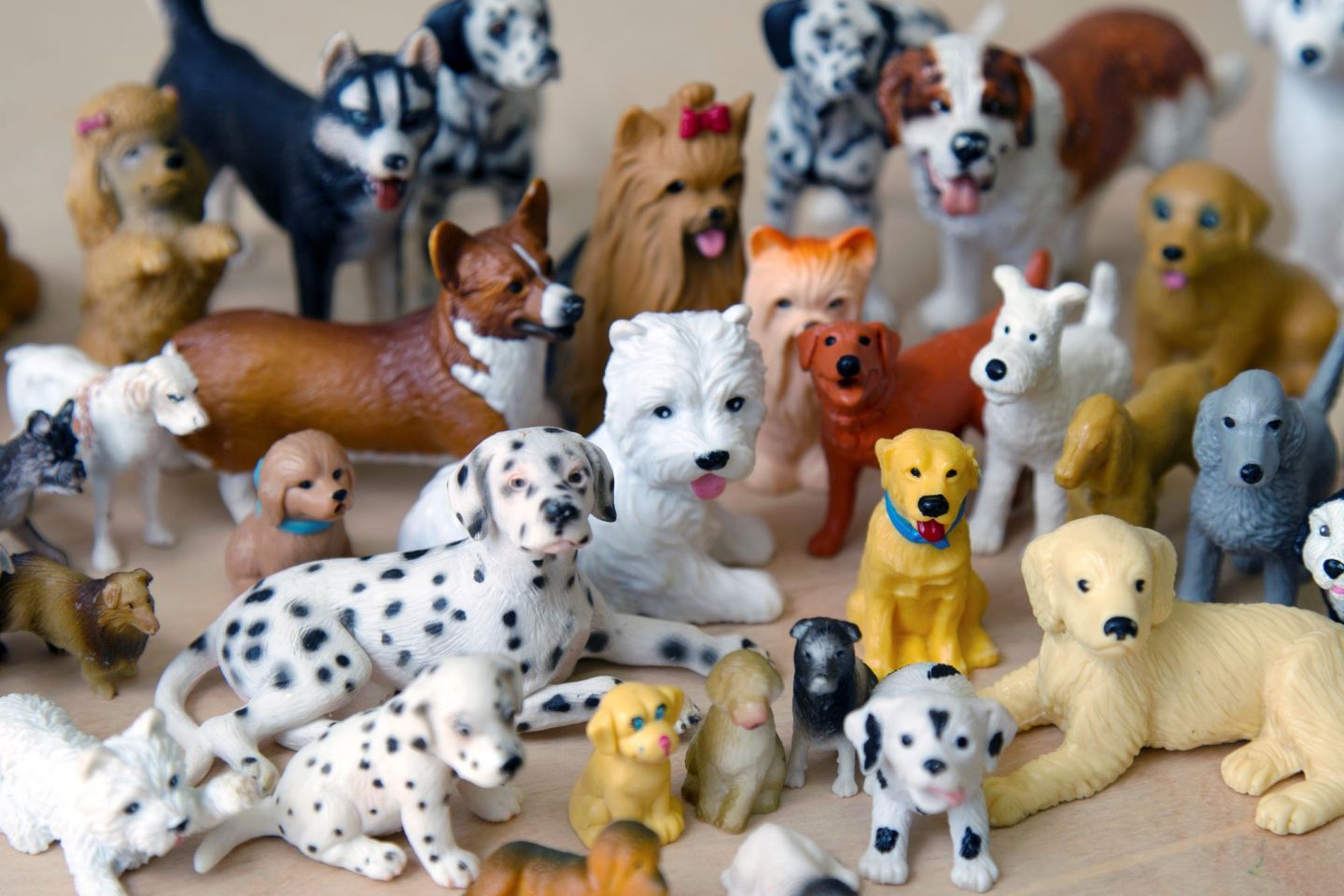 Plastic dog figurines arranged as if posing for a family photo