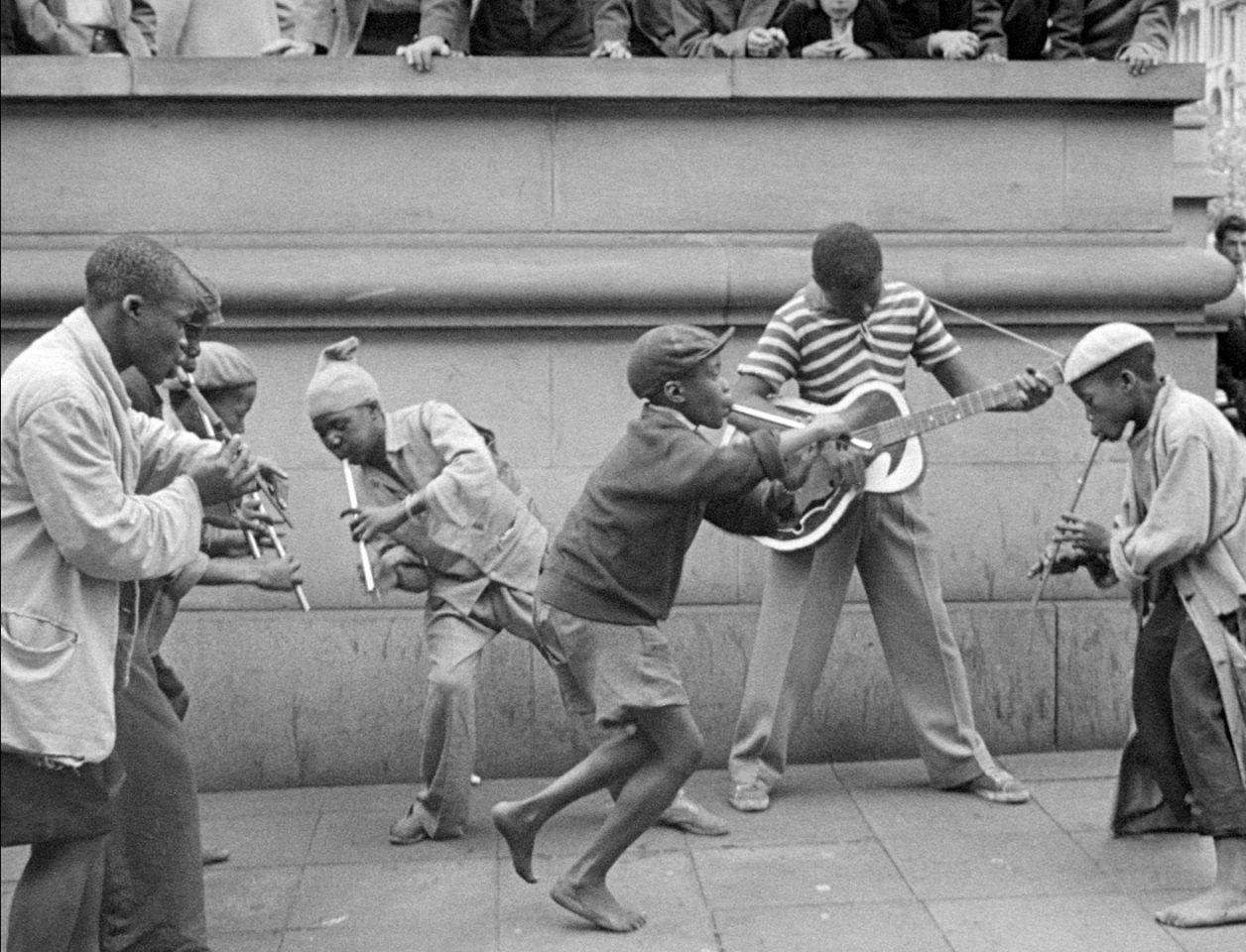 Penny Whistlers and Musicians on the street in the film COME BACK, AFRICA by Lionel Rogosin.