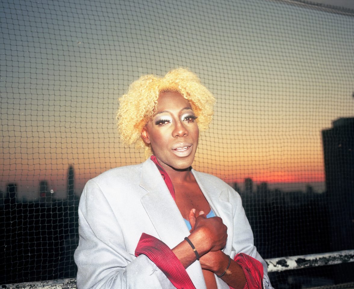 Ms Carrie Stacks in front of a skyline set against a sunset