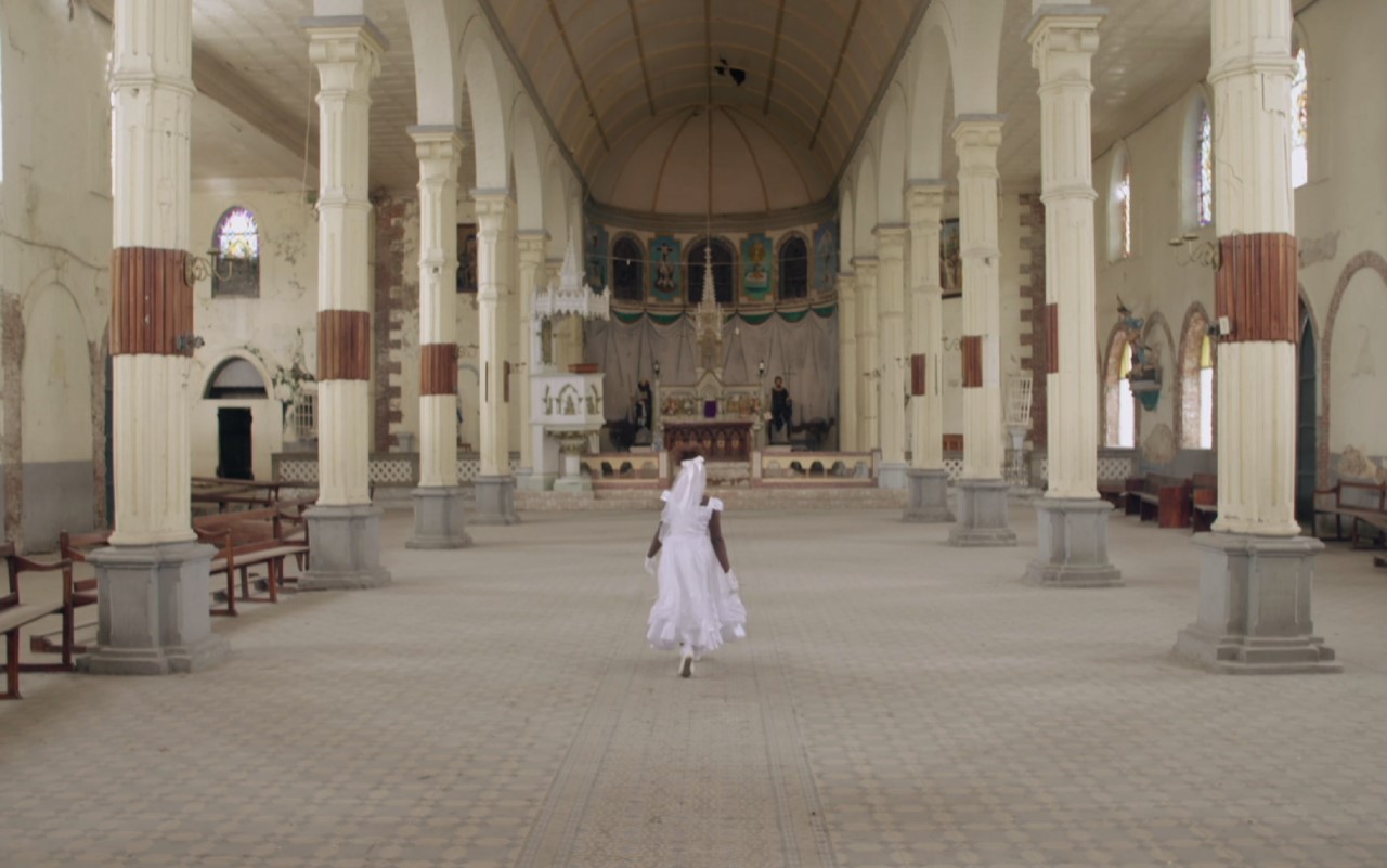 A figure in white stood inside a religious building