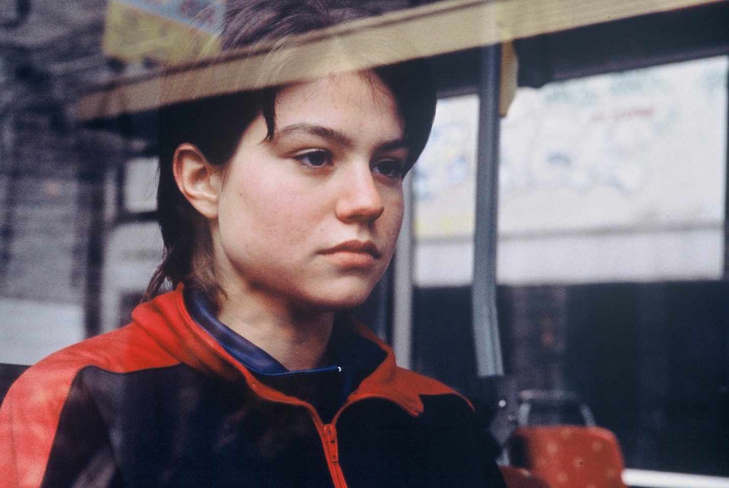 Young person looks out of a window