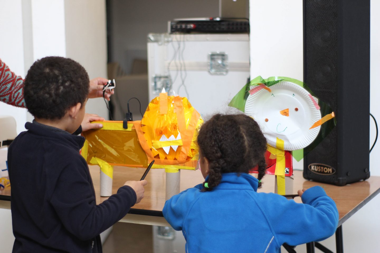 Children play with paper animals they have created