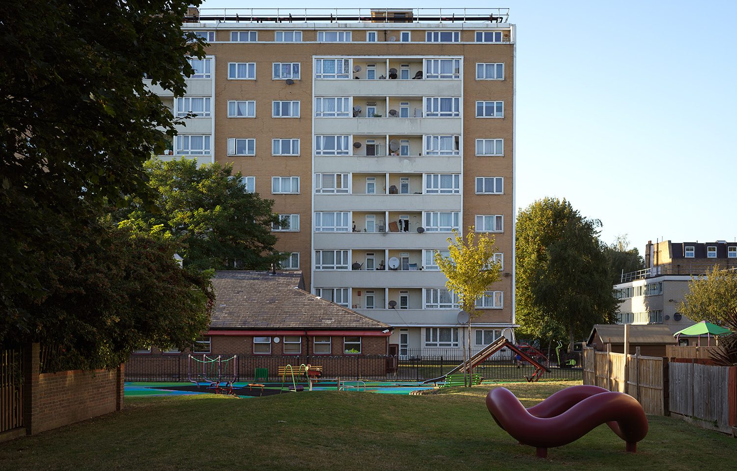 Isamu Noguchi's red sculpture positioned on the grass near Pelican estate's central playground