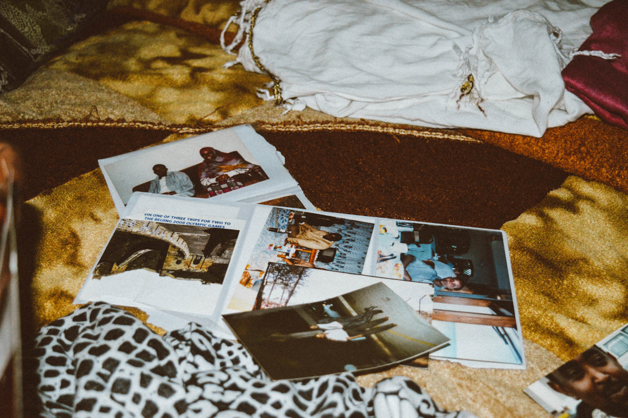 A selection of family photographs overlap on a bed