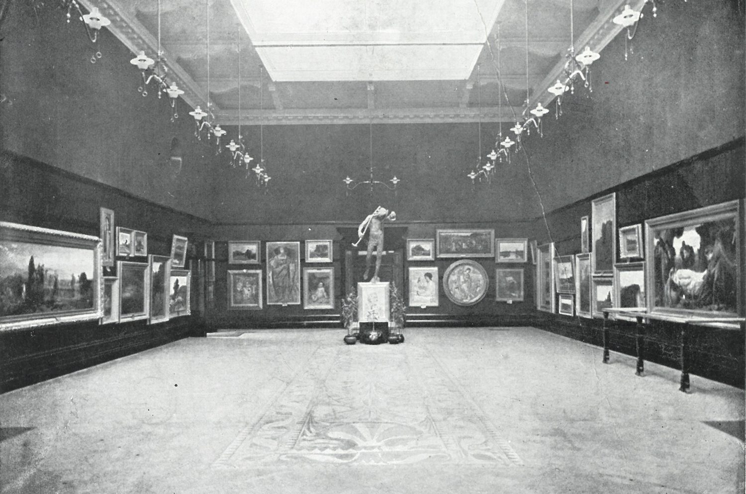 Black and white photograph of the Main Gallery with work on the walls and the marquetry floor visible