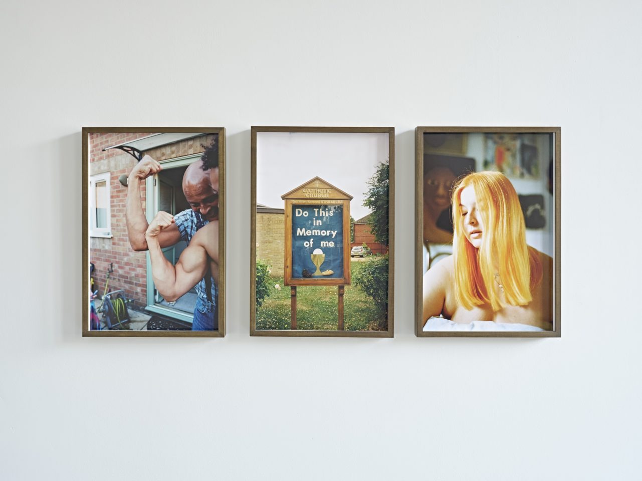 Three framed photographs hanging on a white wall.