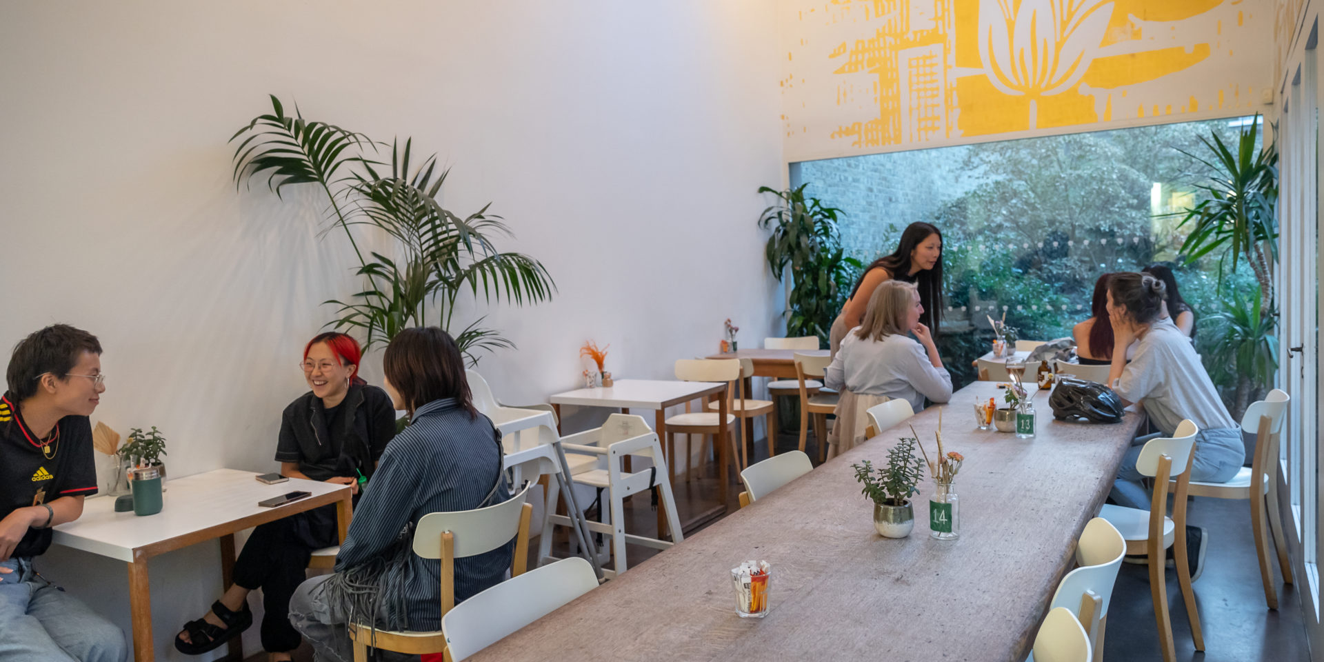 People sit at tables in a cafe