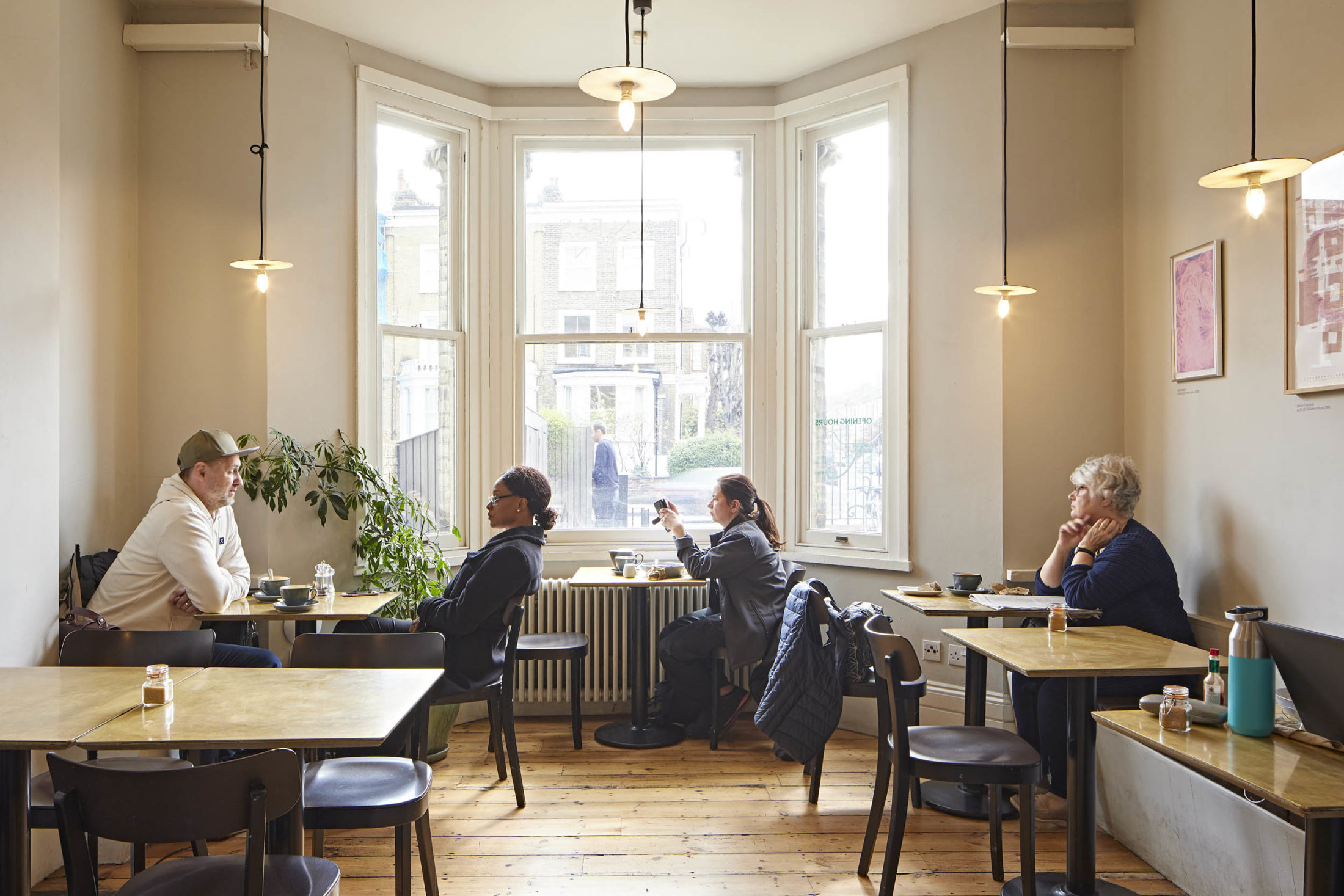 People sit at tables in a cafe