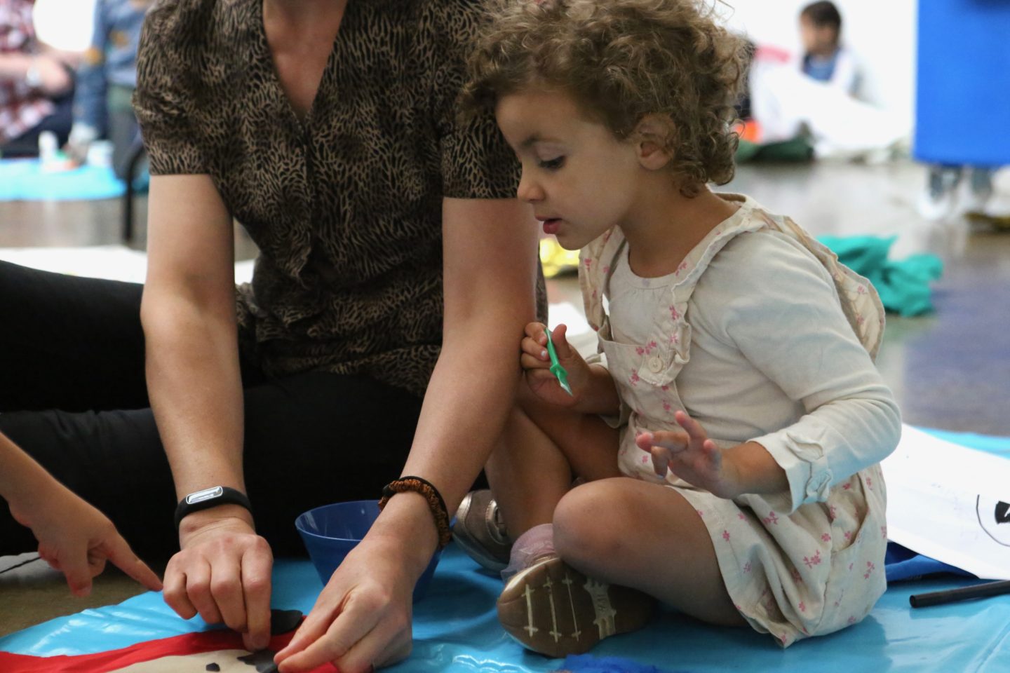 A child and an adult do art activities together