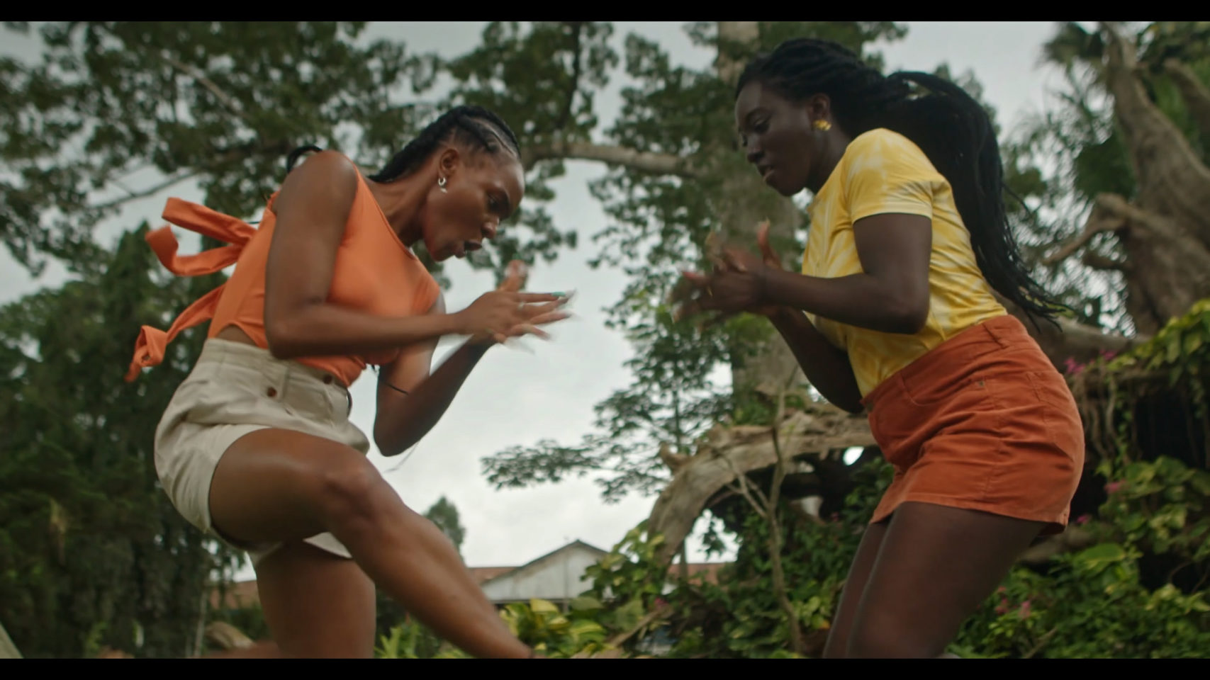 Two girls clap their hands and jump