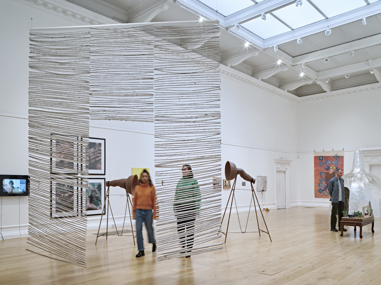 Visitors in a gallery surrounded by works of art