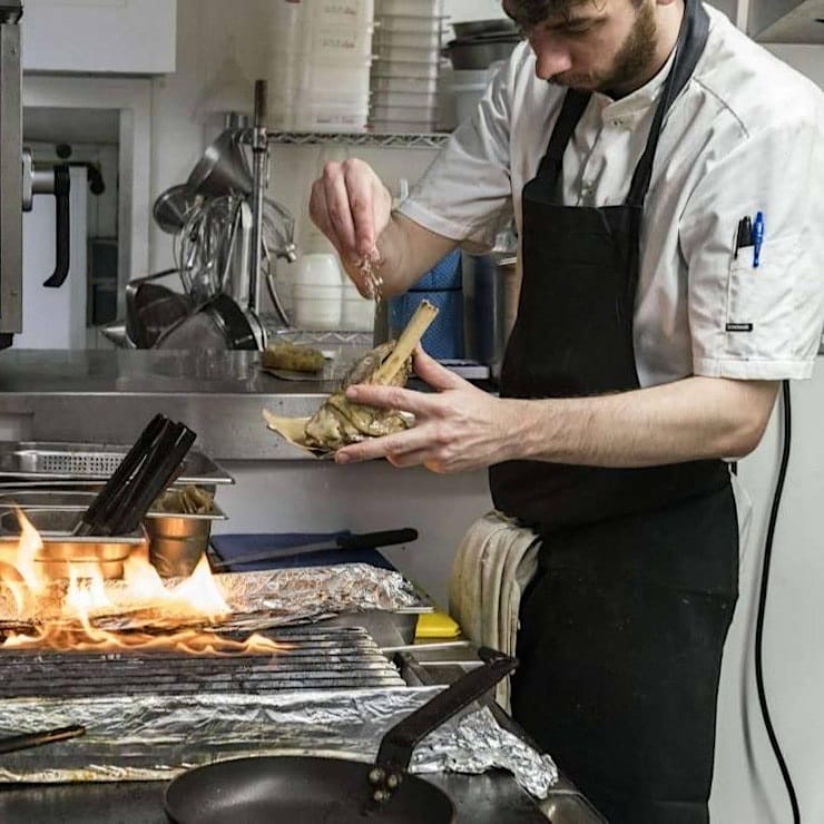 A chef cooking in a kitchen.