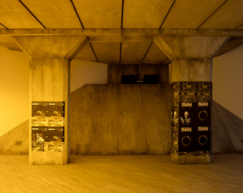 A motorway bridge installed in a gallery with yellow lighting