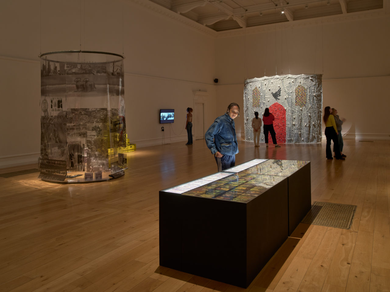 People stand in an art gallery looking at art