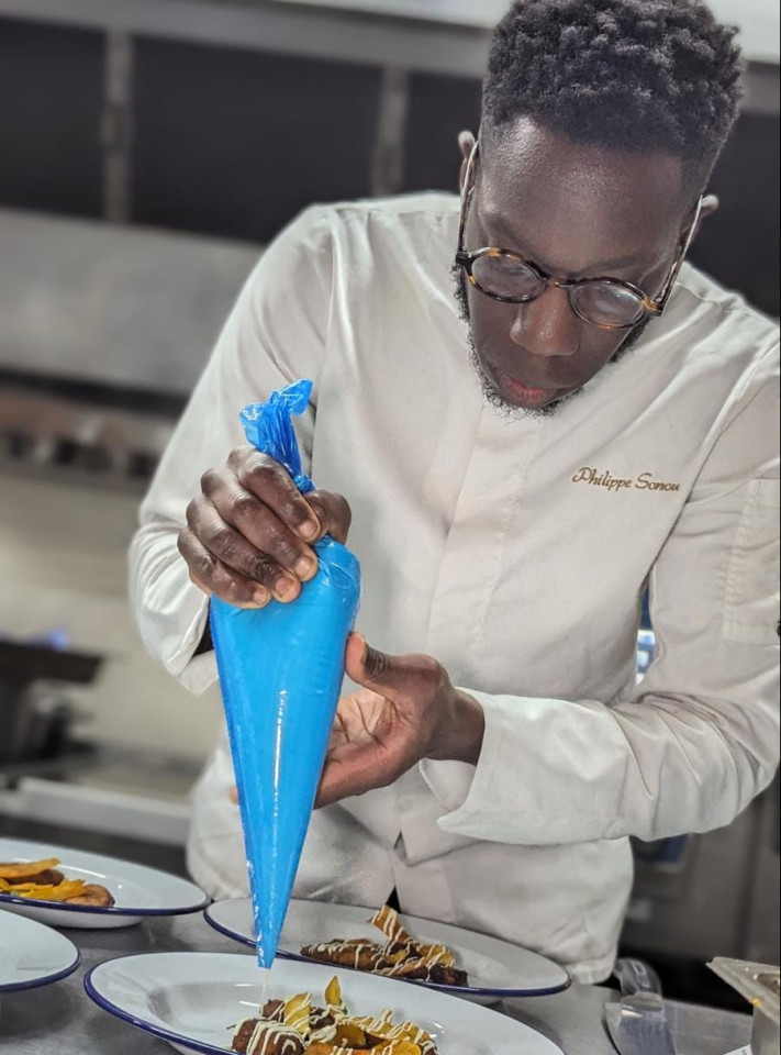 Chef Philippe Sonou working in a kitchen