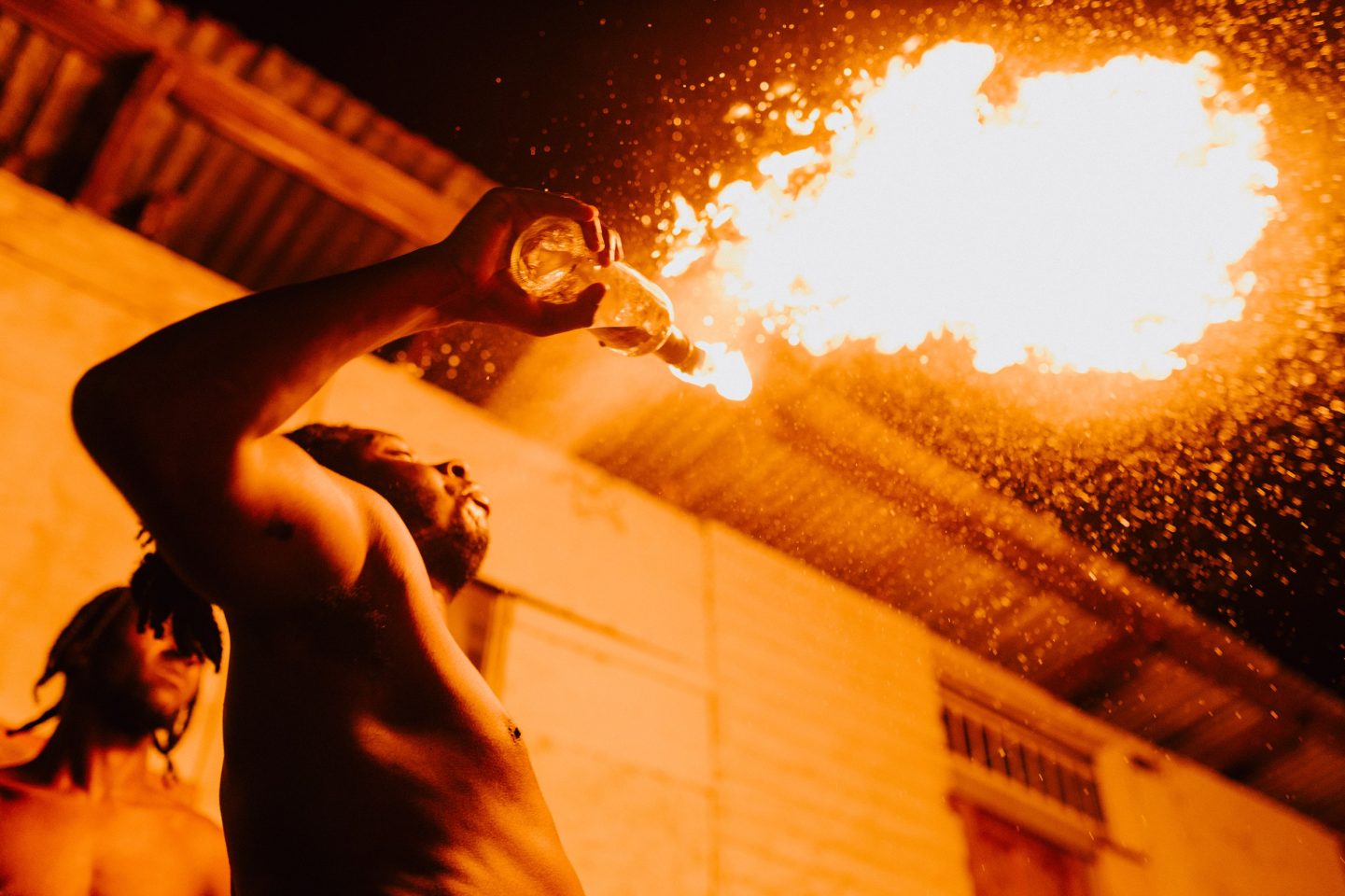 A photo taken at night of a fire breather.