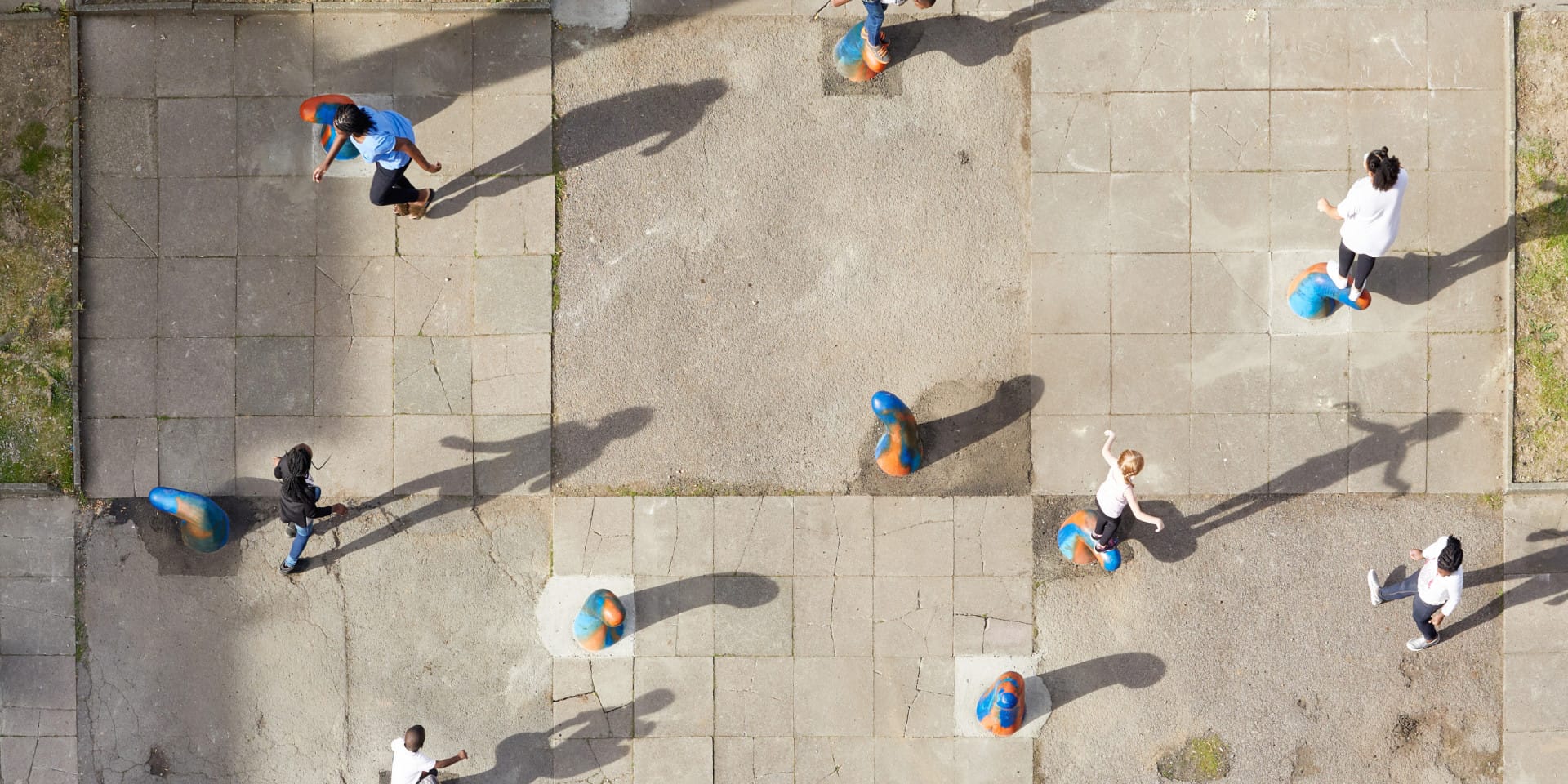 An aerial view of children playing on structures made by Gabriel Lester.