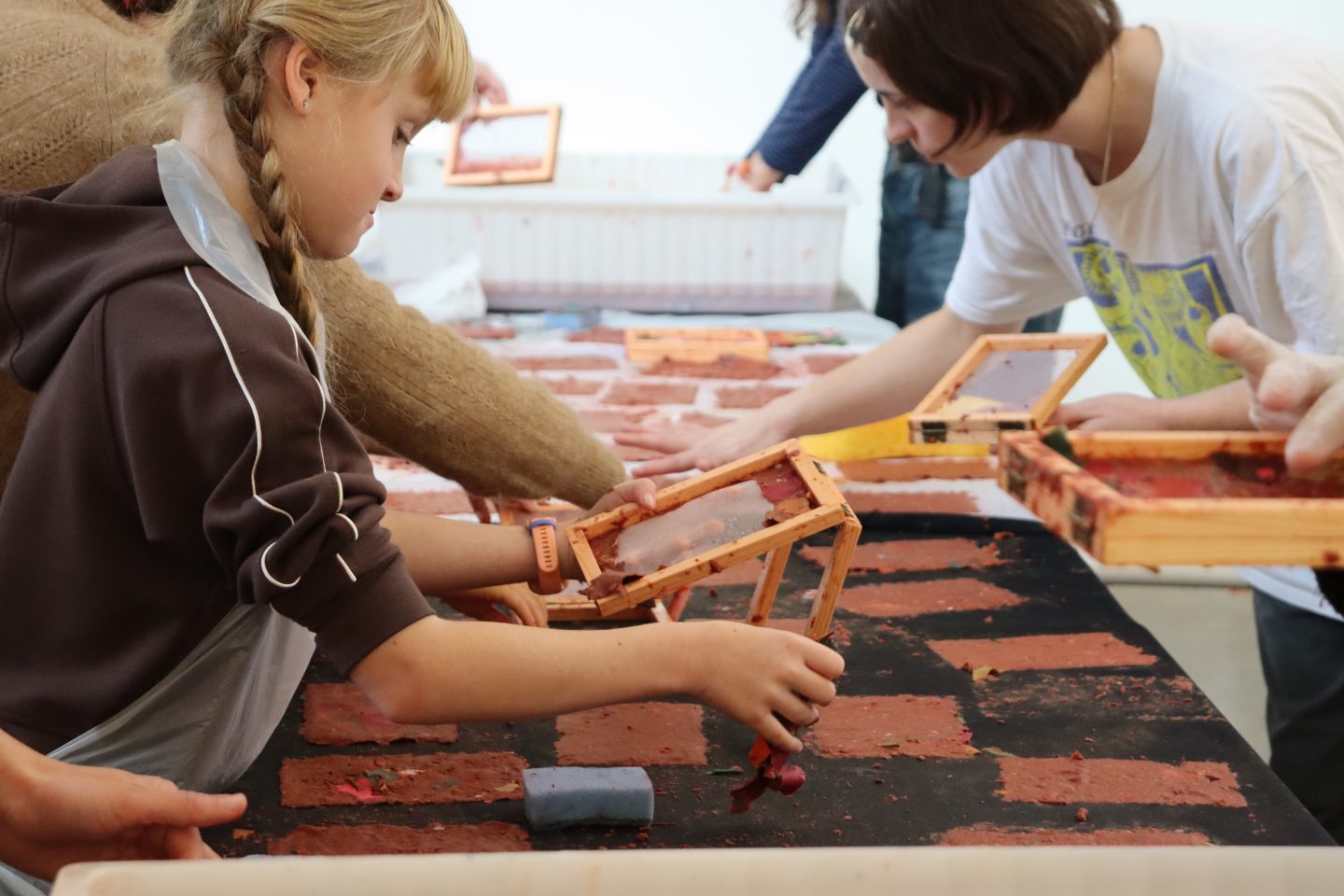 Children and adults take part in a creative workshop.